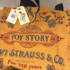 Disney mustard tote with navy and deep red Toy Story graphic